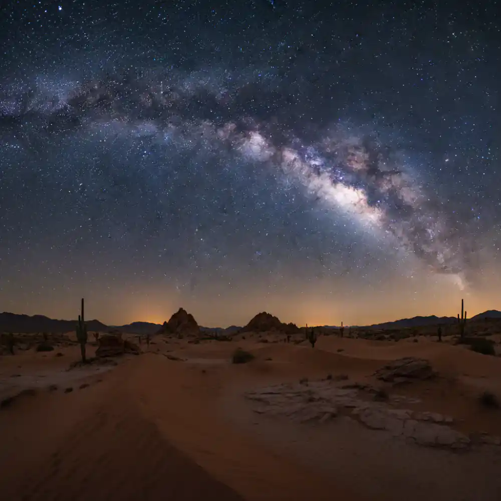 Milky way shining brightly over a vast desert landscape